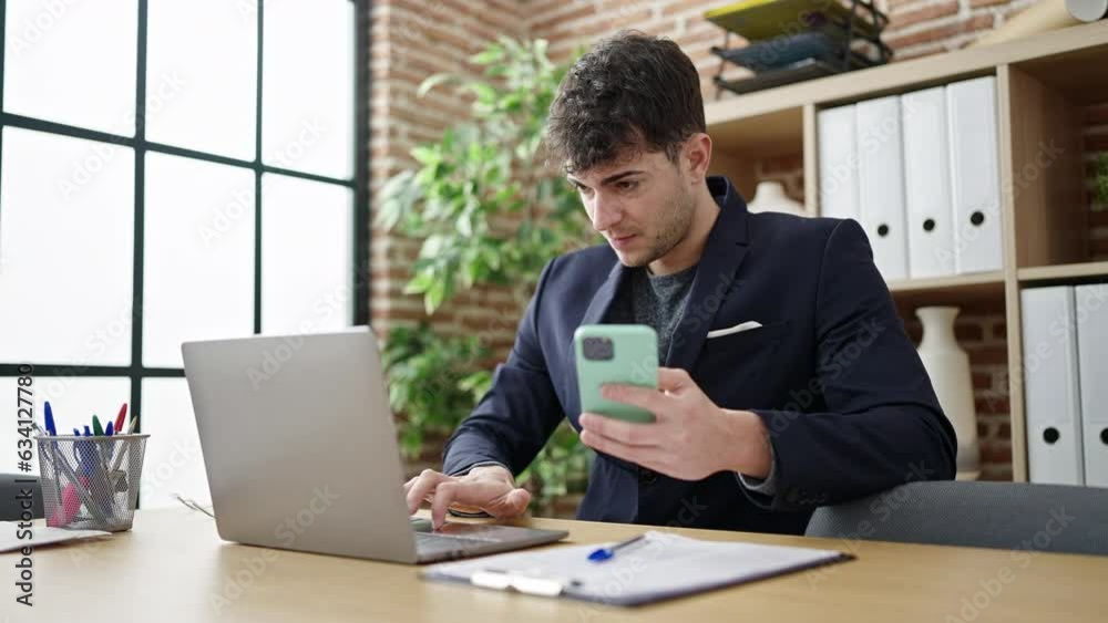 Young hispanic man business worker using laptop and smartphone at office Young hispanic man business worker using laptop and smartphone at office