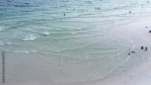 Families enjoy swimming, kids playing with white sandy, clean clear turquoise water, gentle waves along quiet Emerald Coast, Seagrove beach, Santa Rosa, Florida, USA photo