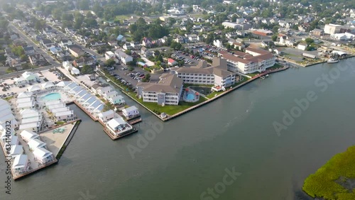 Aerial View to Chincoteague Island, Virginia, USA with marinas, hotels and parking lots. Flight on a drone over the embankment and the bay. photo