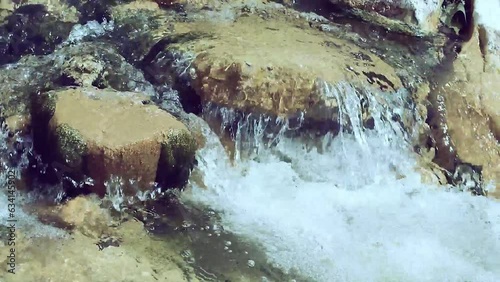 fresh,clear and transparent flowing water of the stream Mollarino,tributary of the Melfa river,amid the Italian Apennine Mountains of the south-east Lazio region photo