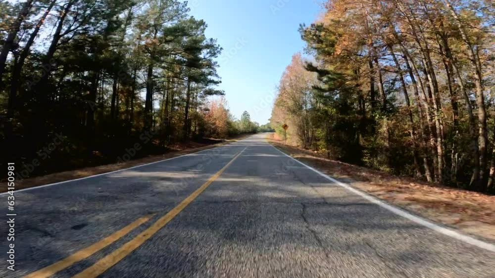 Water tower POV driving Country paved road fall colors in rural Georgia USA Water tower POV driving Country paved road fall colors in rural Georgia USA