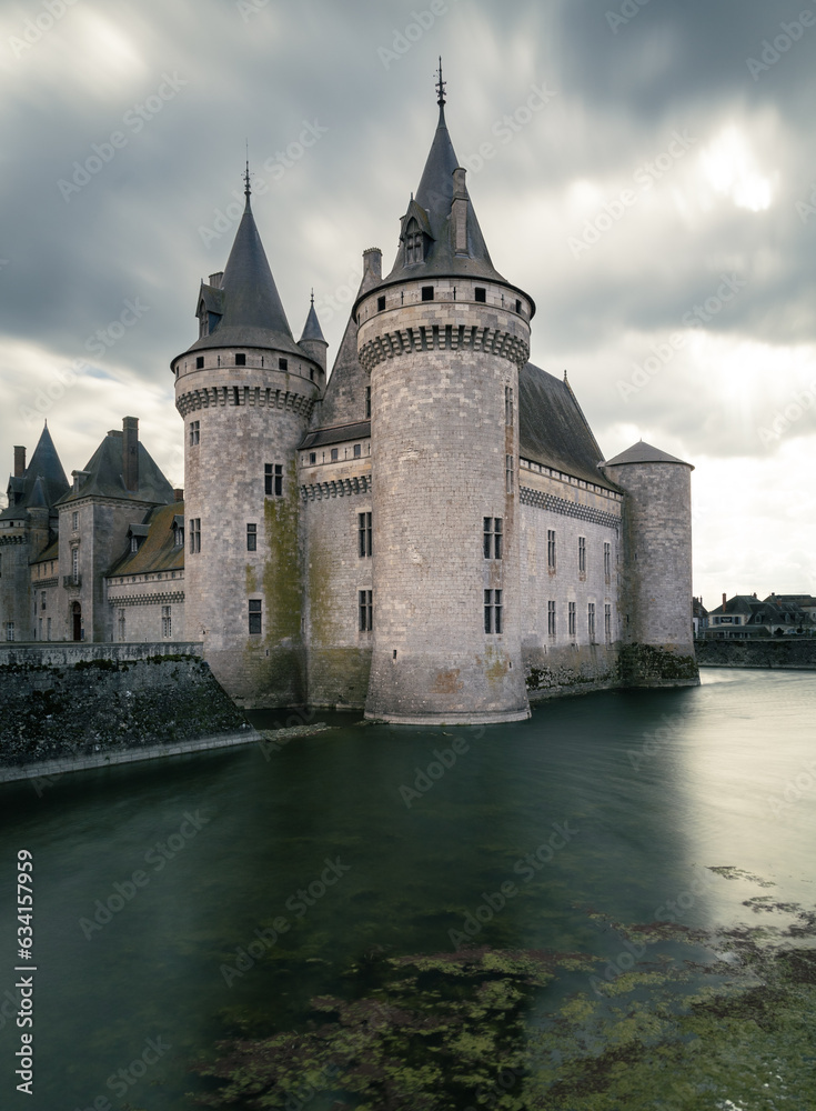 Corner of a castle in the middle of a lake on a cloudy day 
