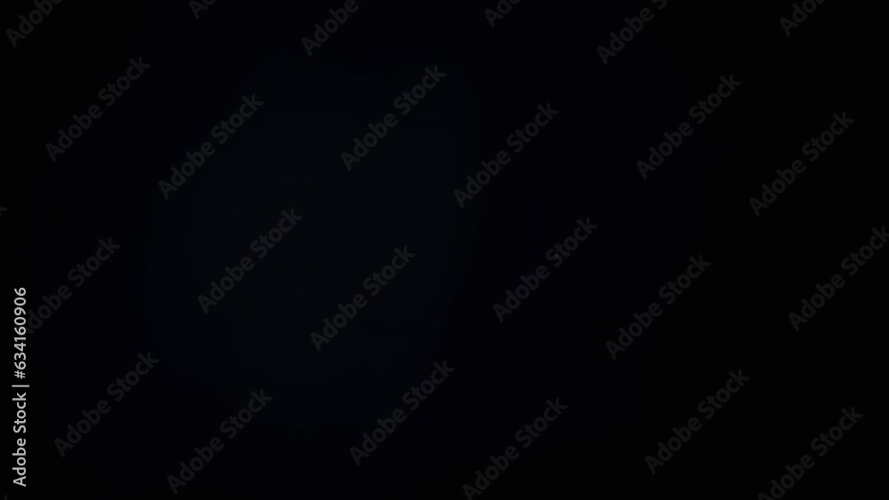 Colorful Soap Bubbles Fly in an Empty Space on Isolated Black Background. Many rainbow transparent bubbles randomly rotate, float, fall. Blurred motion. Selective focus. Abstract. Game. Slow motion.