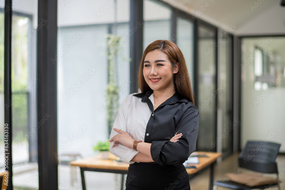 Shot of smile businesswoman standing arms in a modern office. Shot of smile businesswoman standing arms in a modern office.