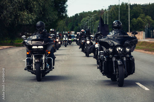 Group of bikers on motorcycles drive fast at the highway