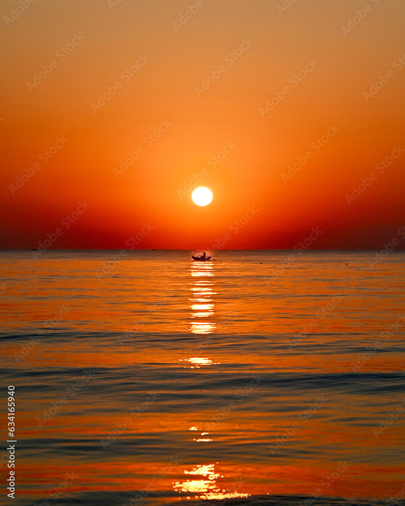 sunrise over the Bay of Bengal, a fisherman on a boat sunrise over the Bay of Bengal, a fisherman on a boat