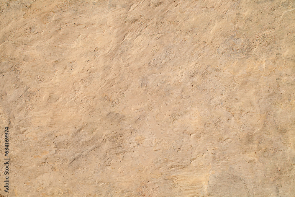 Rough plastered wall painted with old beige paint, background Rough plastered wall painted with old beige paint, background