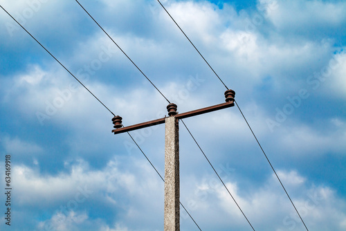 Power  line support pole concrete with high voltage wires and Insulators