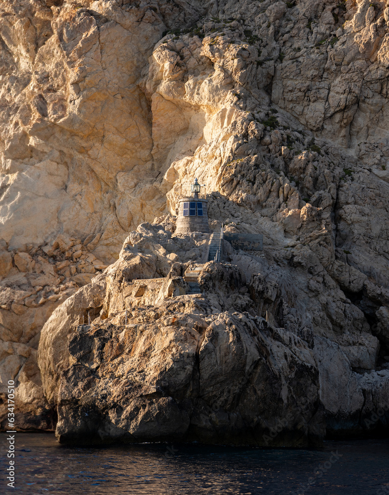 A rock-built lighthouse on Es Vedra illuminated by the sun