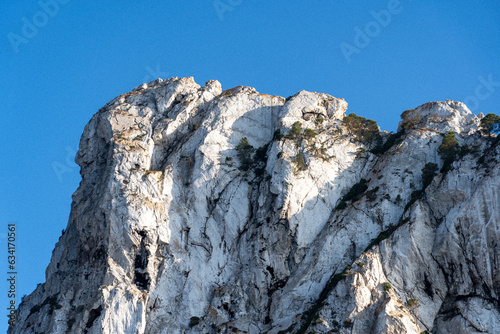 Close-up shot of Es Vedra Ibiza against a blue sky backdrop with sunlight