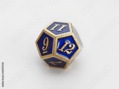 D12 Blue and gold 12 sided dodecahedron dice isolated on white. RPG dice. Dodecahedron DND dice  photo