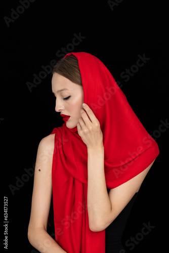 Obraz na płótnie beautiful young woman wearing red in retro fashion style isolated on black backg