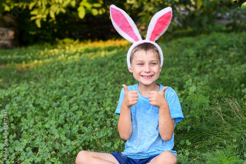 the boy with the ears of a hare gives a thumbs up.