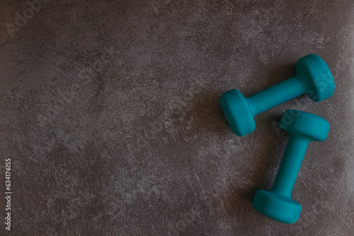 dumbbells green on black isolated background with copy space