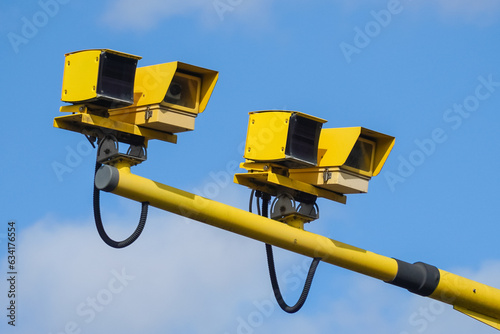Yellow traffic speed control cameras on a road