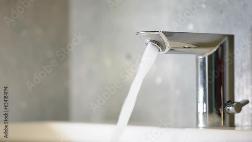 Faucet in the bathroom. A jet of water from a tap, a drop of water - saving resources