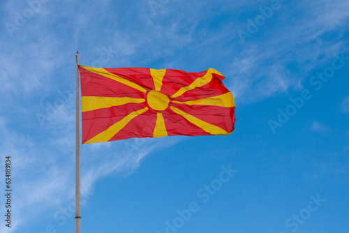 Foto North Macedonian flag waving atop of its pole