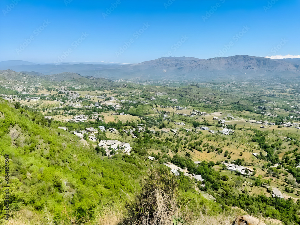 Panoramic View of a Valley with Mountains in the Background