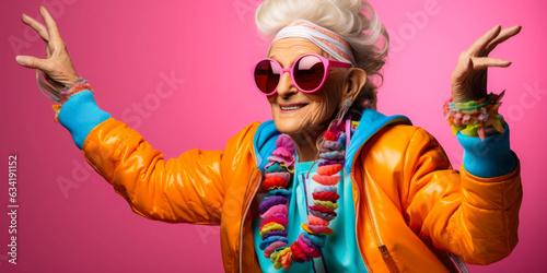 Funny Grandmother: Stylish Senior Posing on Colored Background photo