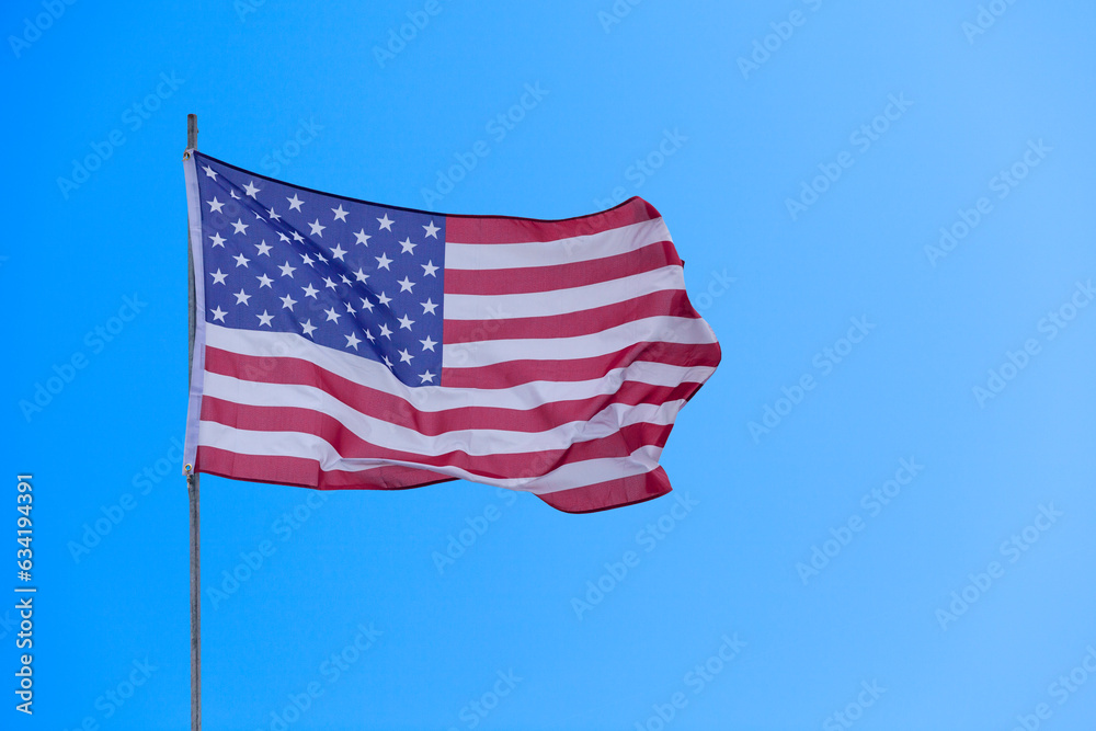 American flag waving atop of its pole
