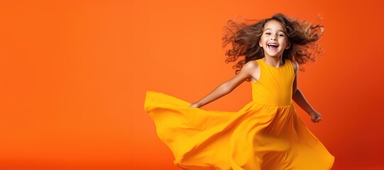 Cute Young Happy Girl iDancing on a Orange Background with Space for Copy