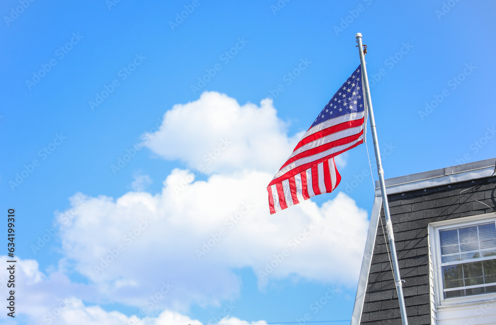 US flag waves proudly, symbolizing unity, freedom, history, and ideals. Stars for states, stripes for courage. Patriotic emblem under sunlit sky