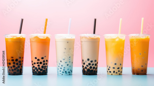 Commercial photography, variety of bobba bubble milk tea in transparent plastic cups standing in a line isolated on flat pastel background. photo