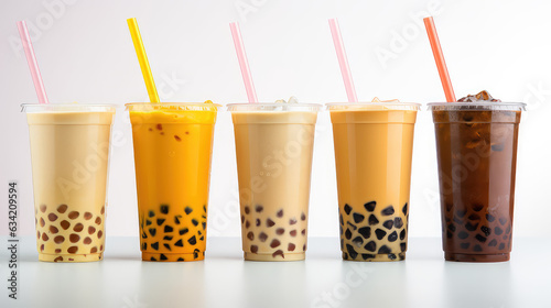 Commercial photography, variety of bobba bubble milk tea in transparent plastic cups standing in a line isolated on flat white background. photo