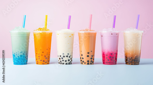 Commercial photography, variety of bobba bubble milk tea in transparent plastic cups standing in a line isolated on flat pastel background.