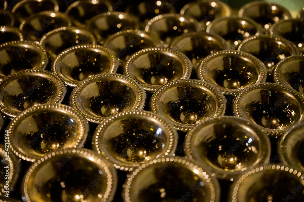 Many bottles of champagne sparkling wine. Visit of undergrounds caves, traditional producing of champagne wine in Cote des Bar, Aube, south of Champagne, France Many bottles of champagne sparkling wine. Visit of undergrounds caves, traditional producing of champagne wine in Cote des Bar, Aube, south of Champagne, France