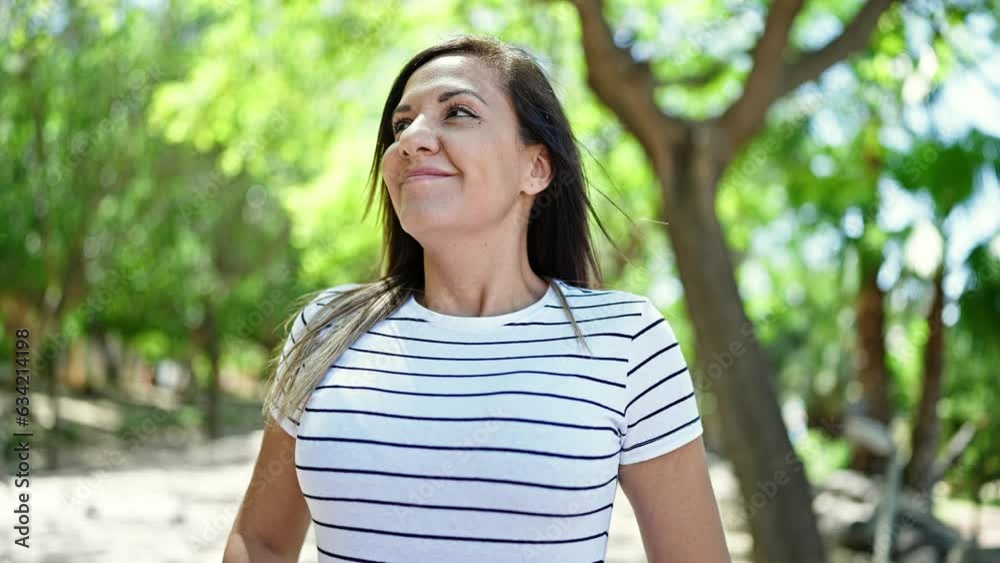 Middle eastern woman smiling confident breathing at park Middle eastern woman smiling confident breathing at park