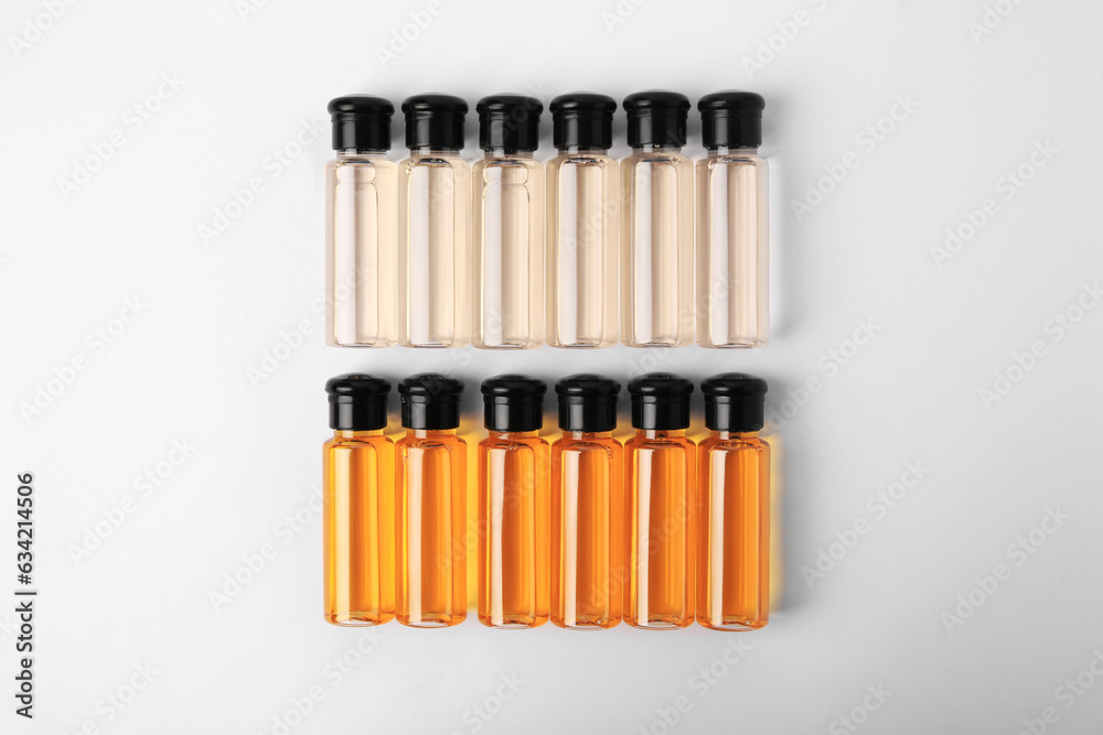 Bottles of cosmetic products on white background, flat lay Bottles of cosmetic products on white background, flat lay