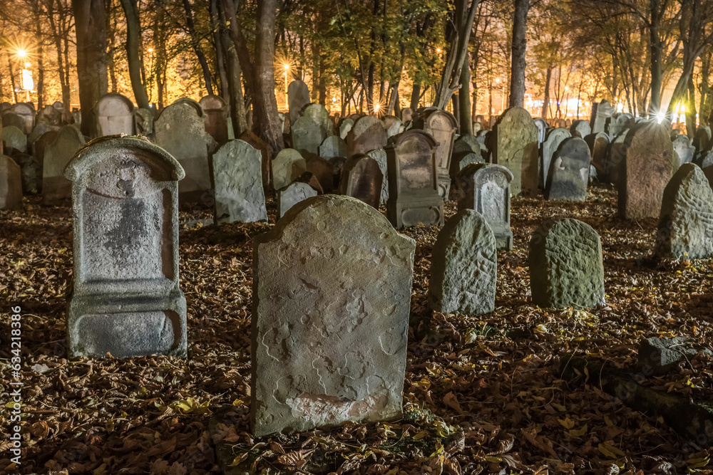 Tombstones in an old cemetery at night.