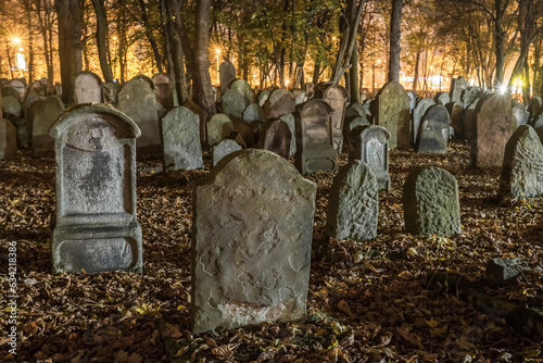 Tombstones in an old cemetery at night. photo