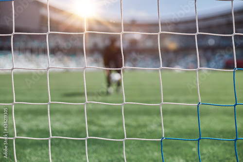 Young african american man holding soccer ball against soccer goal net