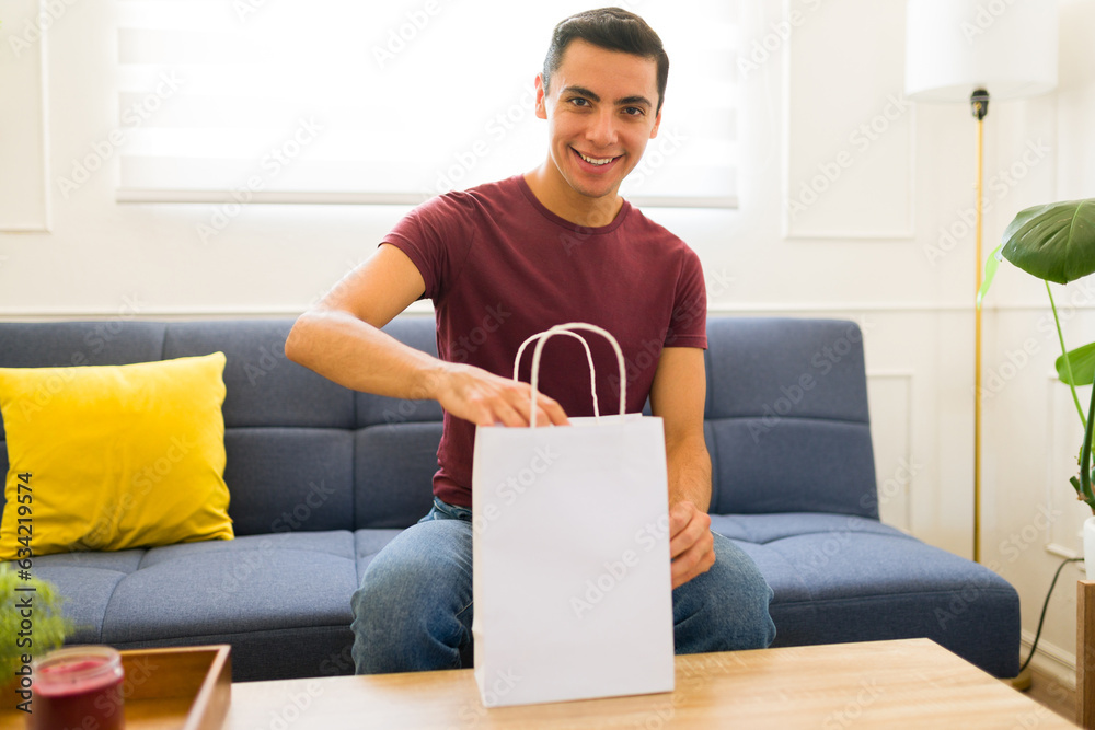 Handsome man using a blank mockup shopping bag Handsome man using a blank mockup shopping bag