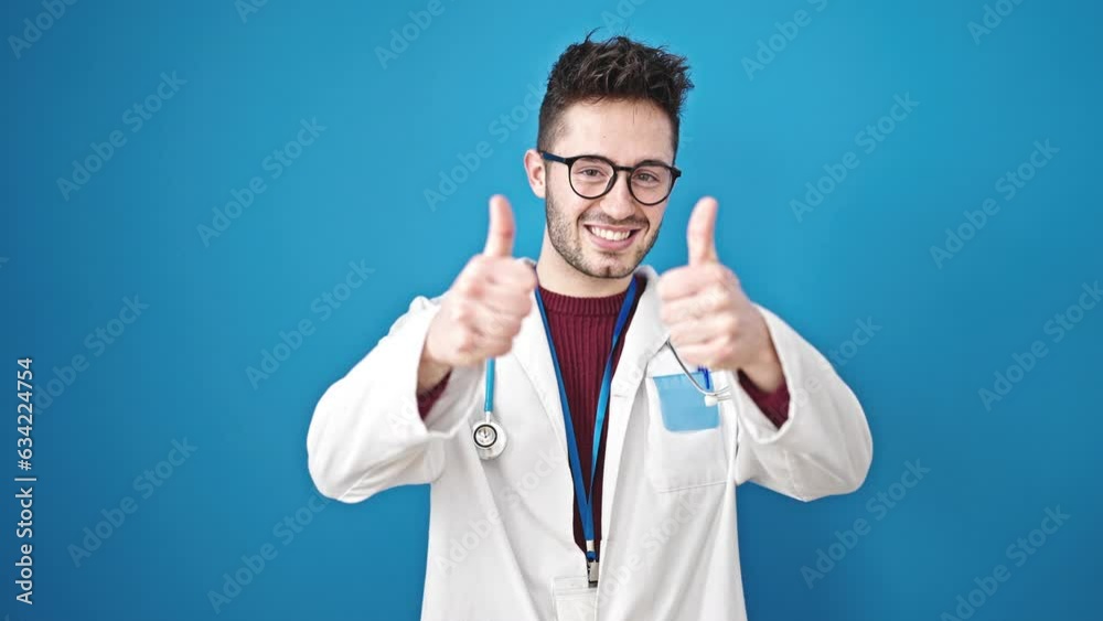 Young hispanic man doctor doing thumbs up over isolated blue background