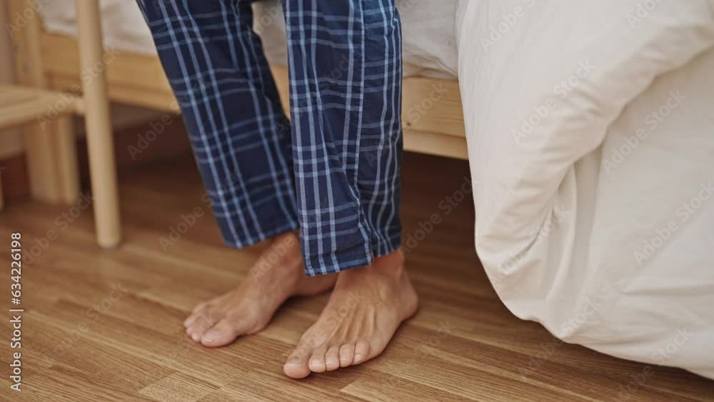 Young hispanic man stand up of bed at bedroom Young hispanic man stand up of bed at bedroom