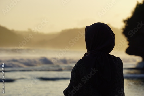 Lonely girl enjoy luxury sunset on the beach during summer vacations