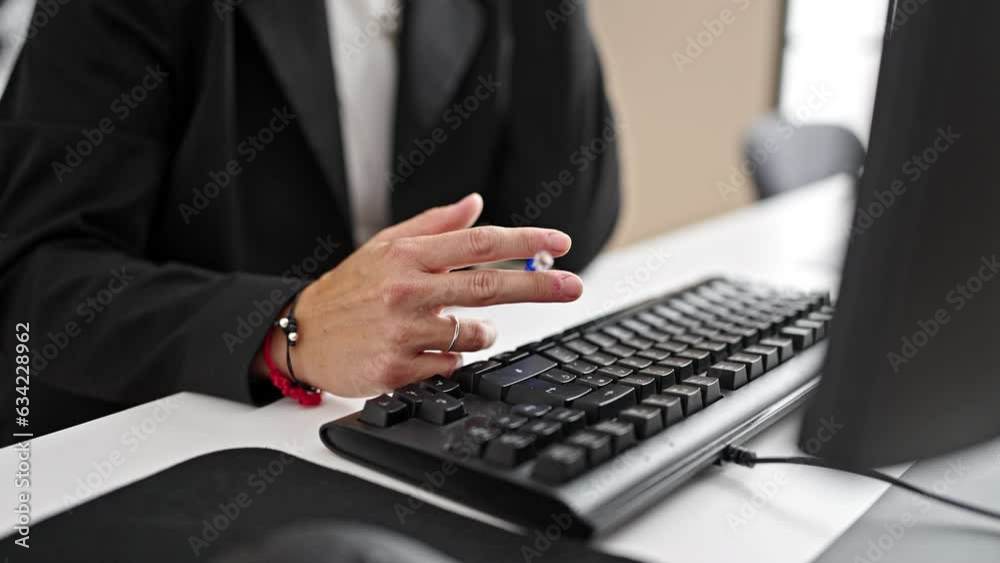 Young woman business worker using computer holding pen at office Young woman business worker using computer holding pen at office