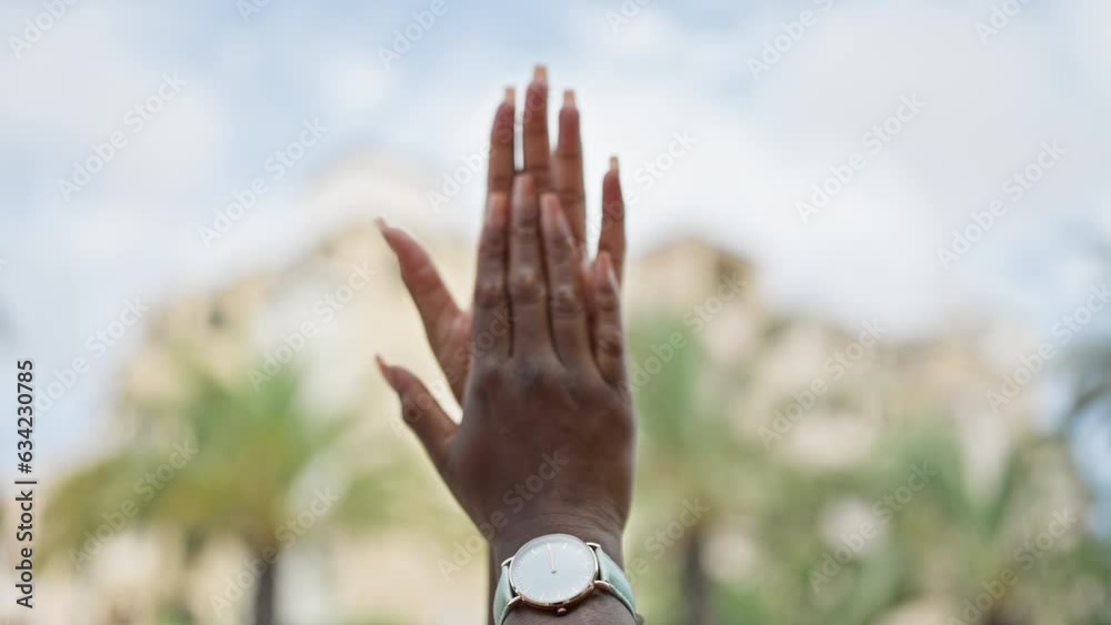 African american woman clapping hands at street