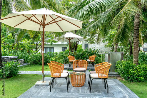 bamboo and rattan tables and chairs in a quiet and green tropical garden