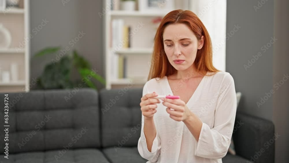 Young redhead woman waiting pregnancy test result at home Young redhead woman waiting pregnancy test result at home