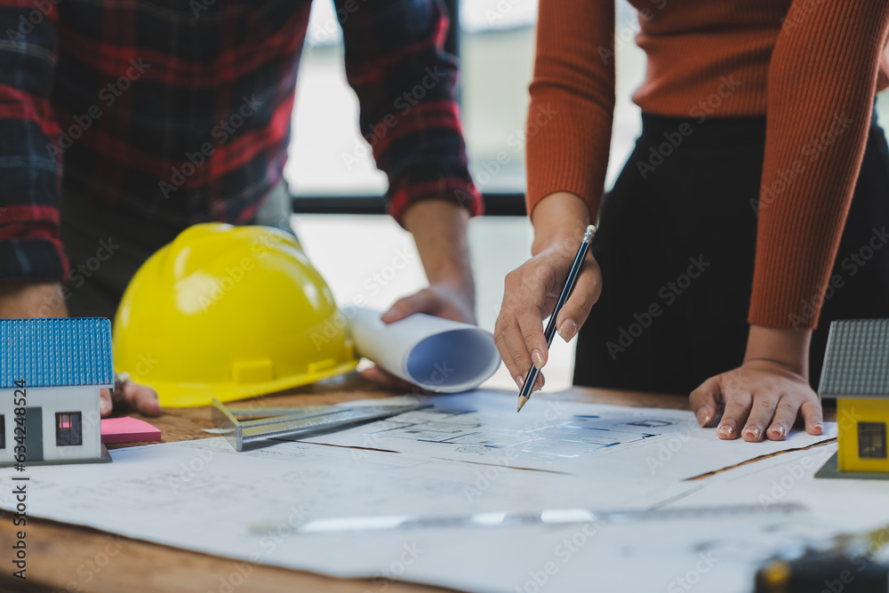 Engineer team working in office with blueprints Planning meeting for architectural work construction project business house structure design real estate concept. Engineer team working in office with blueprints Planning meeting for architectural work construction project business house structure design real estate concept.