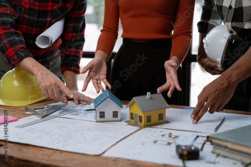 Engineer team working in office with blueprints Planning meeting for architectural work construction project business house structure design real estate concept.