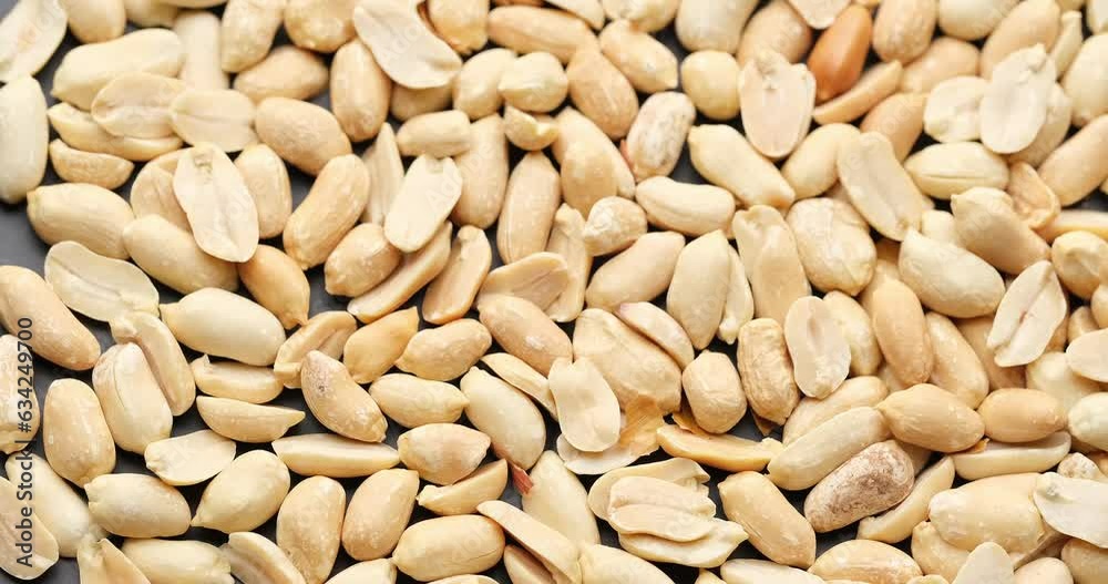 Whole shelled peanut nuts kernels close-up on rotating platform Whole shelled peanut nuts kernels close-up on rotating platform