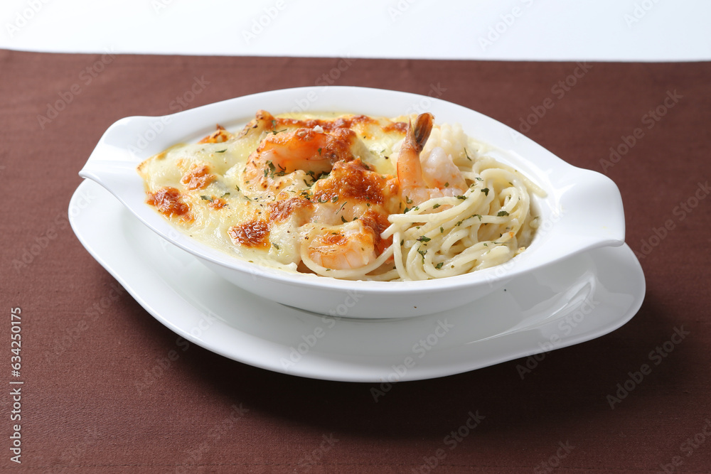 oven baked creamy cheese carbonara cream sauce pasta noodle with fresh big prawn seafood chicken chop in bowl on brown cloth white background design western chef cuisine halal food menu for cafe oven baked creamy cheese carbonara cream sauce pasta noodle with fresh big prawn seafood chicken chop in bowl on brown cloth white background design western chef cuisine halal food menu for cafe