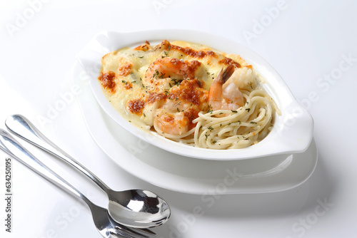 oven baked creamy cheese carbonara cream sauce pasta noodle with fresh big prawn seafood chicken chop in bowl on brown cloth white background design western chef cuisine halal food menu for cafe