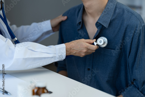 Health care and treatment concept. Senior female doctor using stethoscope. The patient's heartbeat for preliminary processing before examination and diagnosis of the patient's disease at the clinic.