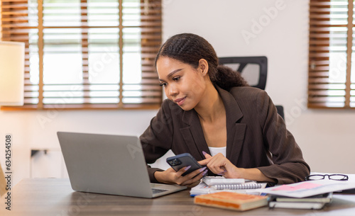 Corporate Communication. Asian Business woman using calculator and laptop for doing math finance, Asian Businesswoman Talking On Mobile Phone Working On Laptop In Modern Office. Free Space